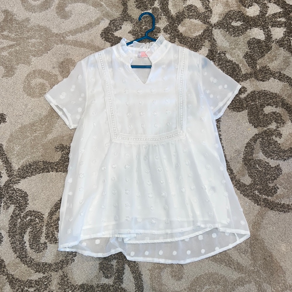 White puff ball shirt with a slight v neck ins use small from C+D+M